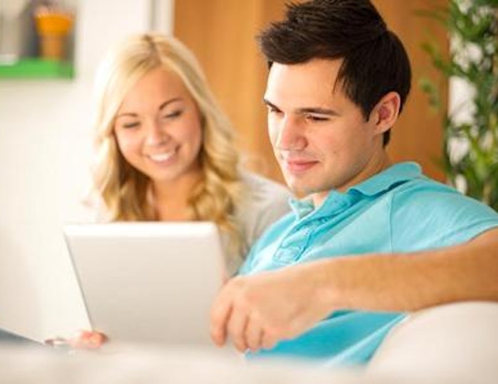 young-couple-browsing-tablet-white-couch_573x300