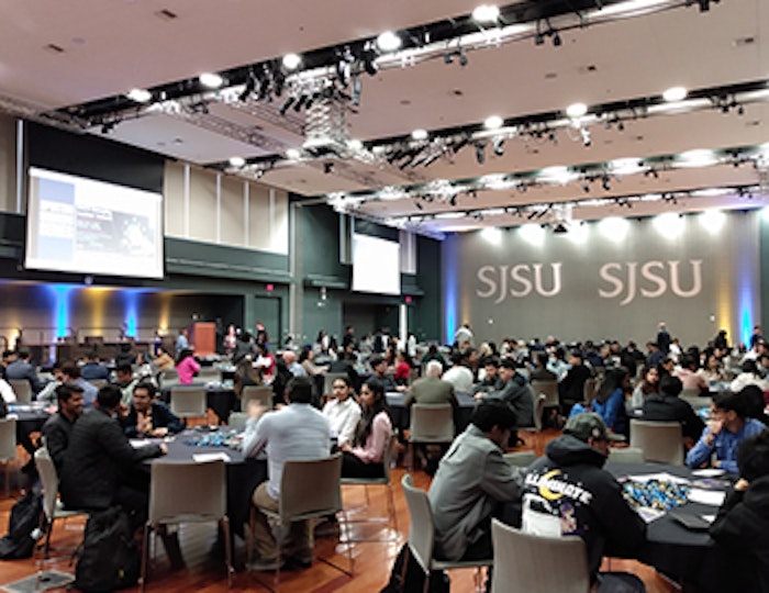 a group of people gather in a San Jose State University conference room