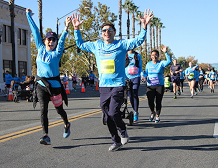 two people running the 2023 Turkey Trot and cheering
