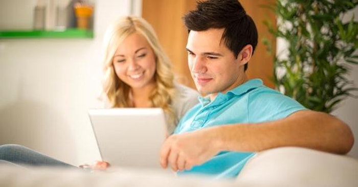 young-couple-browsing-tablet-white-couch_573x300